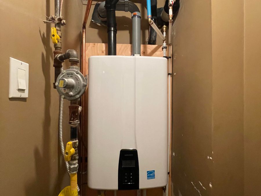 Tankless hot water unit with gas and supply connections, installed by ARSuperfix in Vancouver