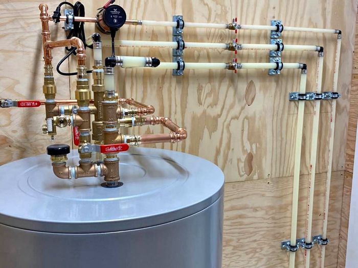 Hot water tank with PEX manifold and recirculation pump