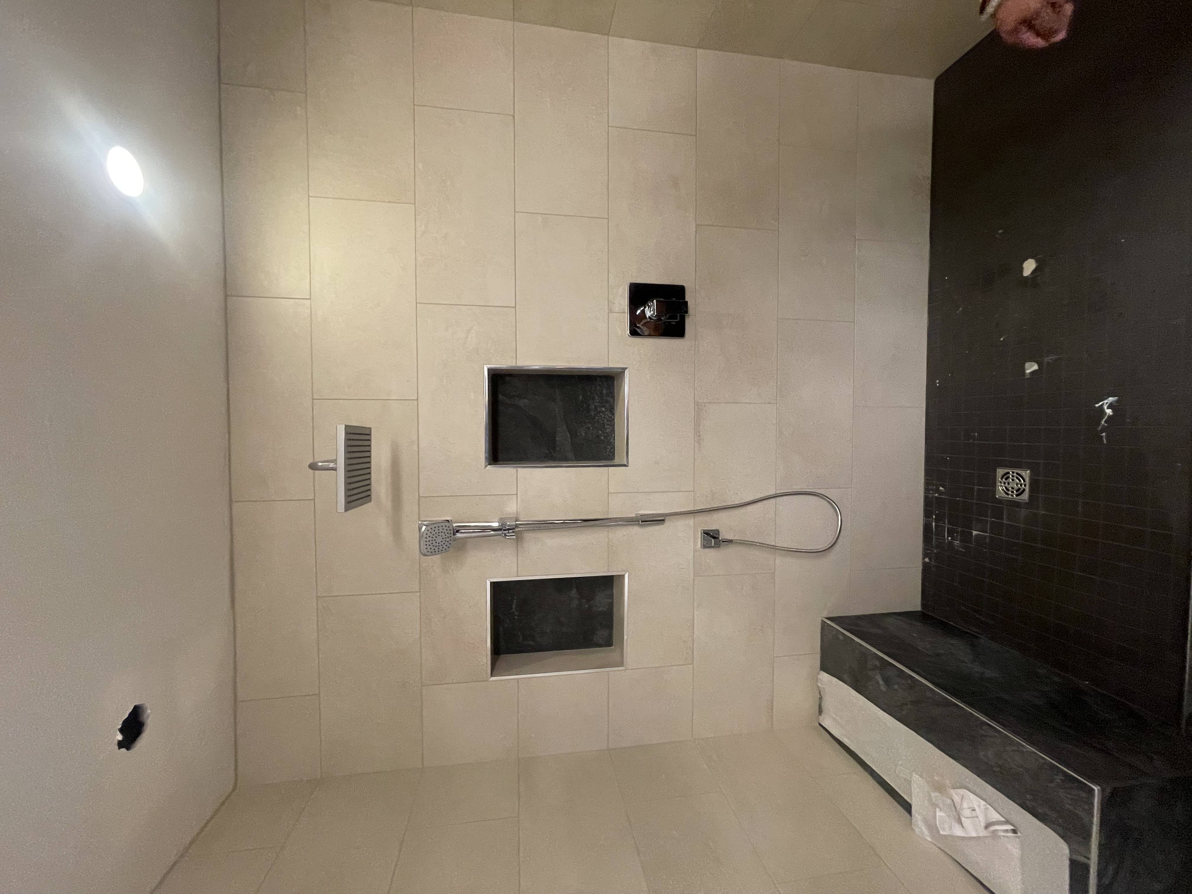 Custom steam shower with hand shower, bench seat and dual niches